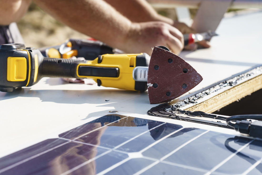 A solar panel and tools in front of a person building and installing their own solar panels